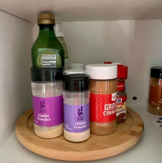 A reviewer&#x27;s photo of the turntable used to organize spices in their cabinet