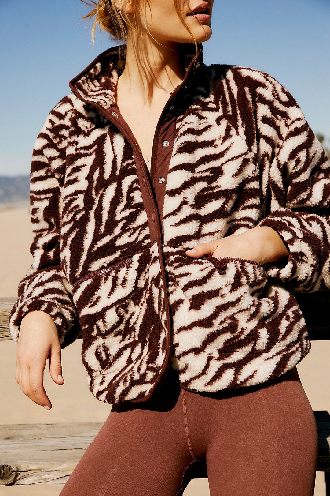 model wearing the brown zebra printed fleece