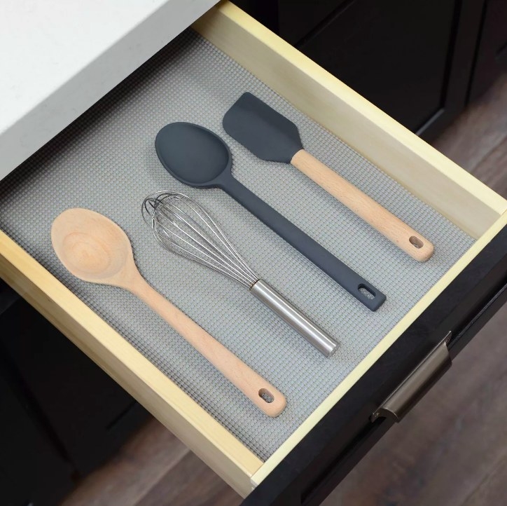 The liner in a drawer with utensils