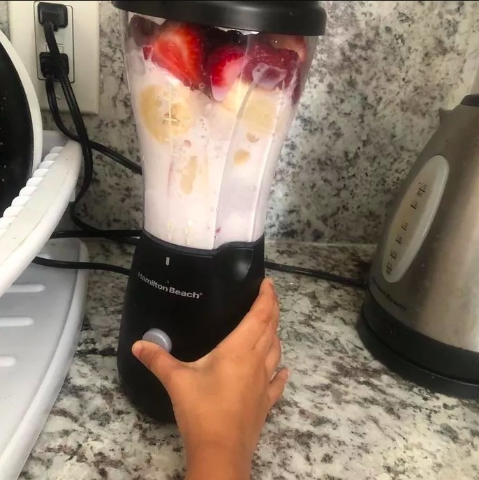 A reviewer&#x27;s photo of the blender making a smoothie