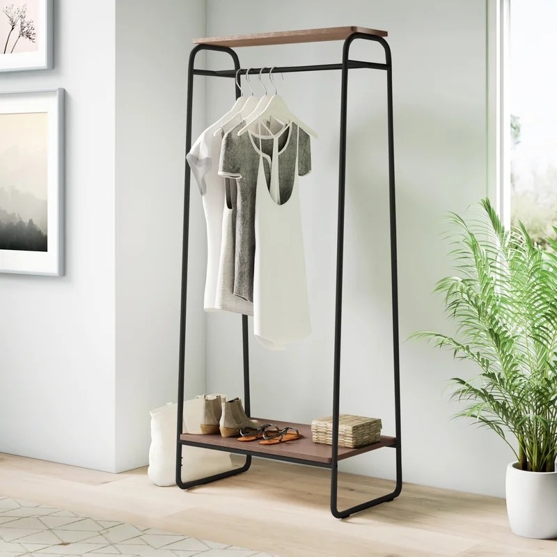 the clothing rack with shirts and shoes on it