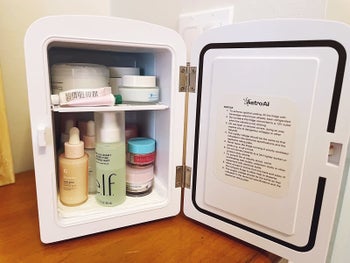 reviewer photo of open mini fridge with different skincare items inside