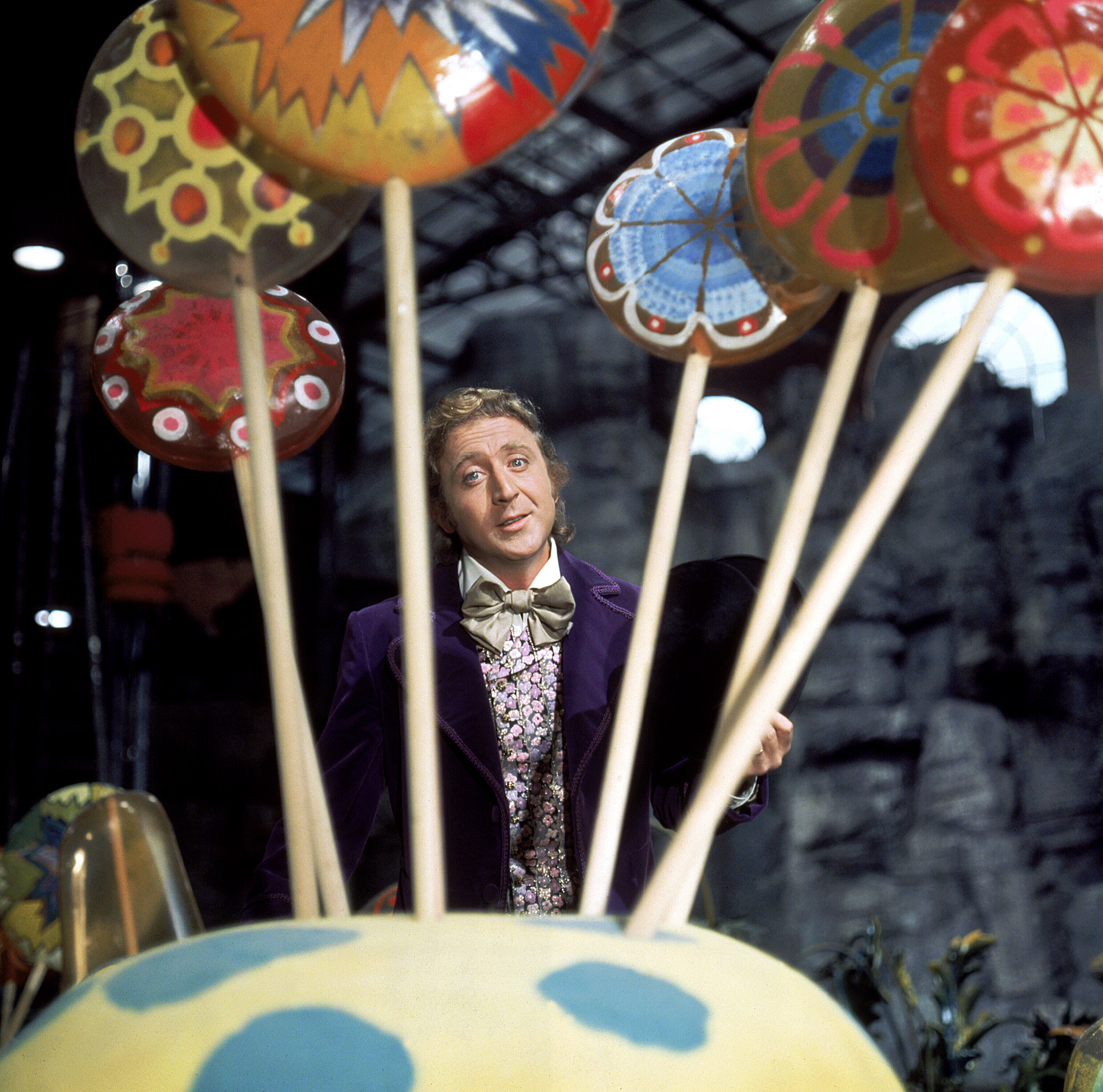 Wonka behind a bunch of giant lollipops