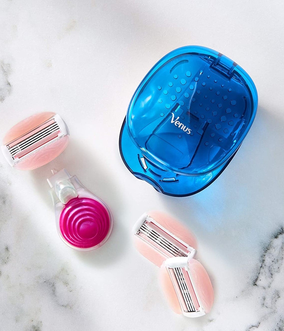 Mini pink razor in a blue case