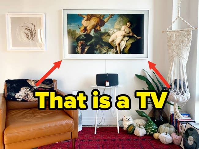 the tv hanging on the wall of buzzfeed editor mallory mower's home looking like a framed painting when the tv is turned off