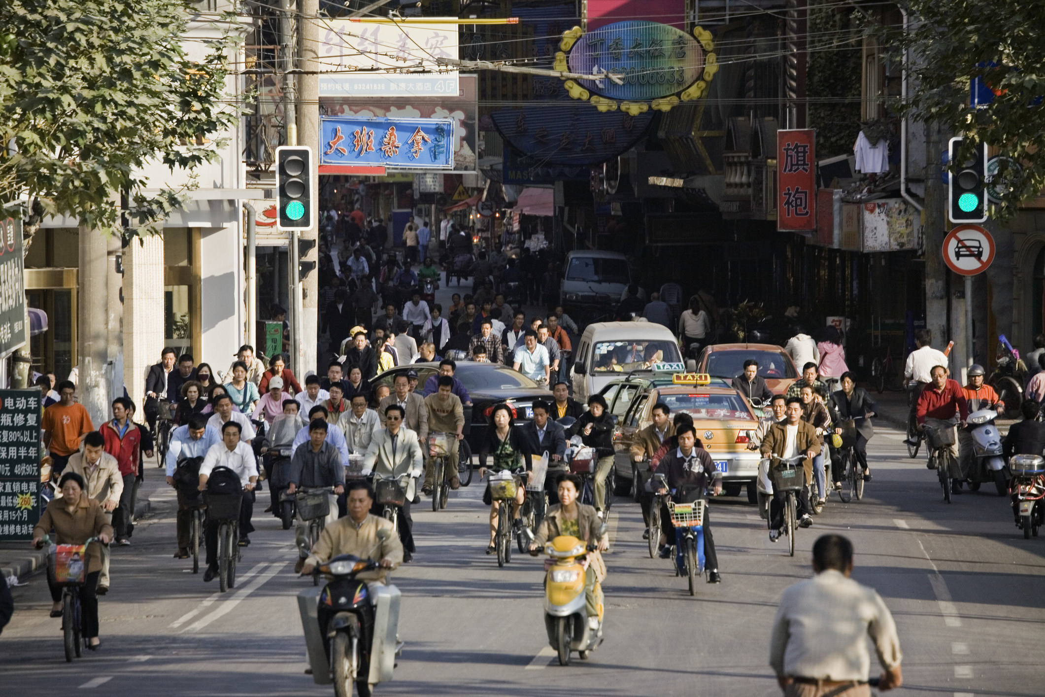 People driving on scooters in Shanghai.