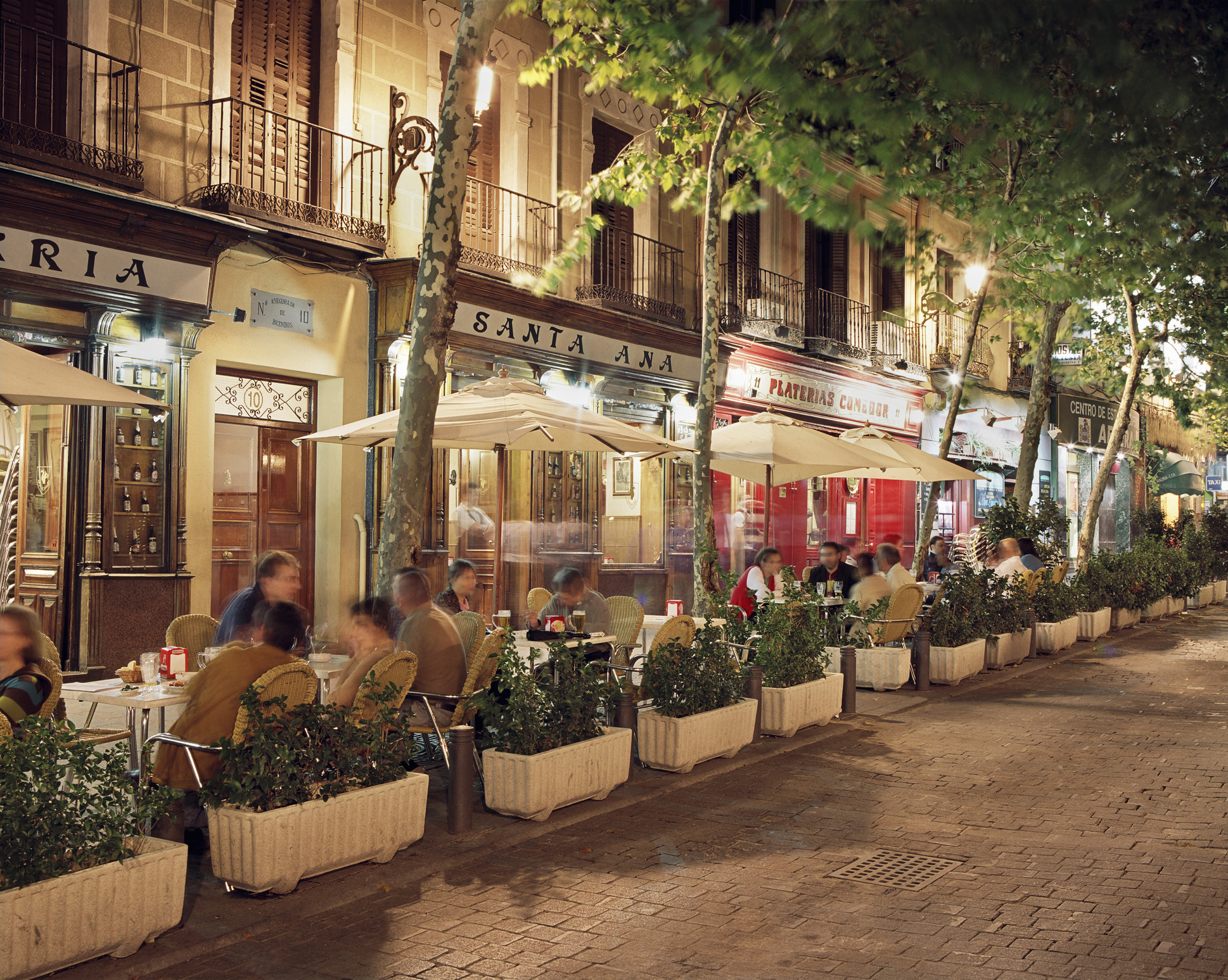 A row of Spanish restaurants at night.
