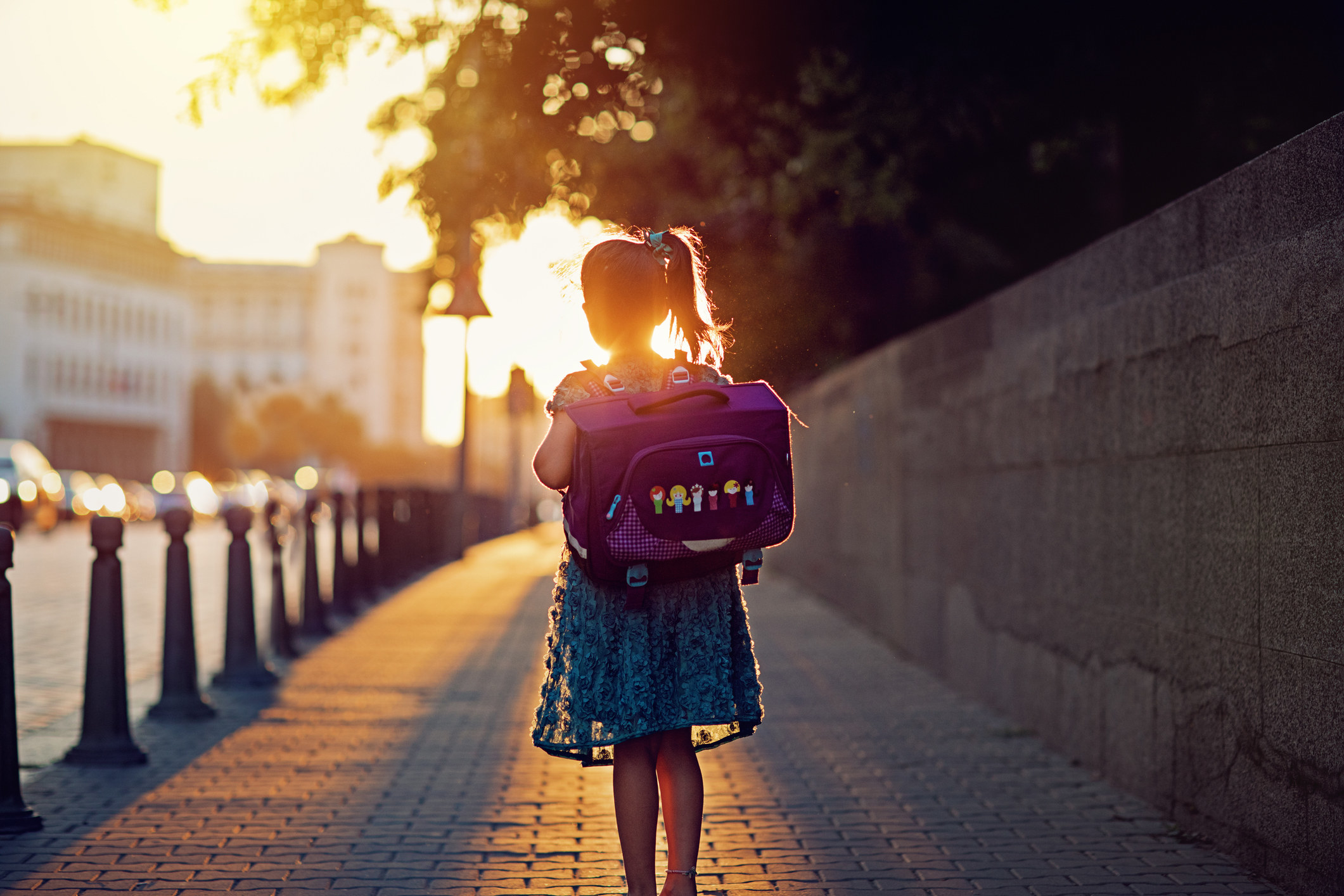 A girl walking home from school alone.