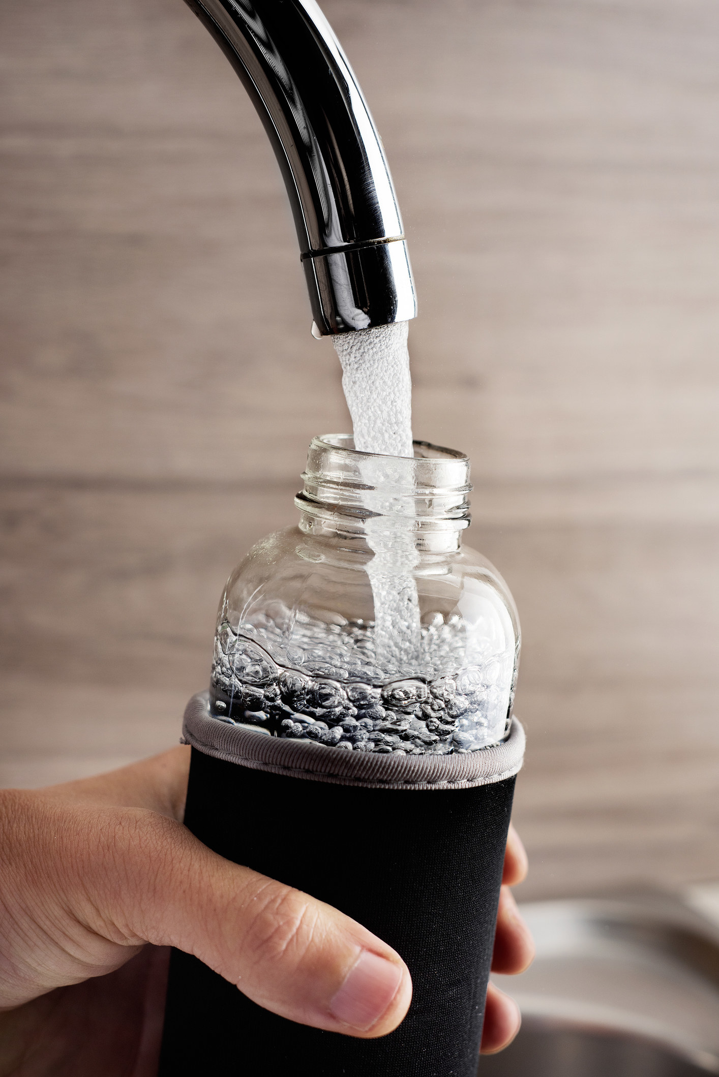 Filling a water bottle with sparkling water.