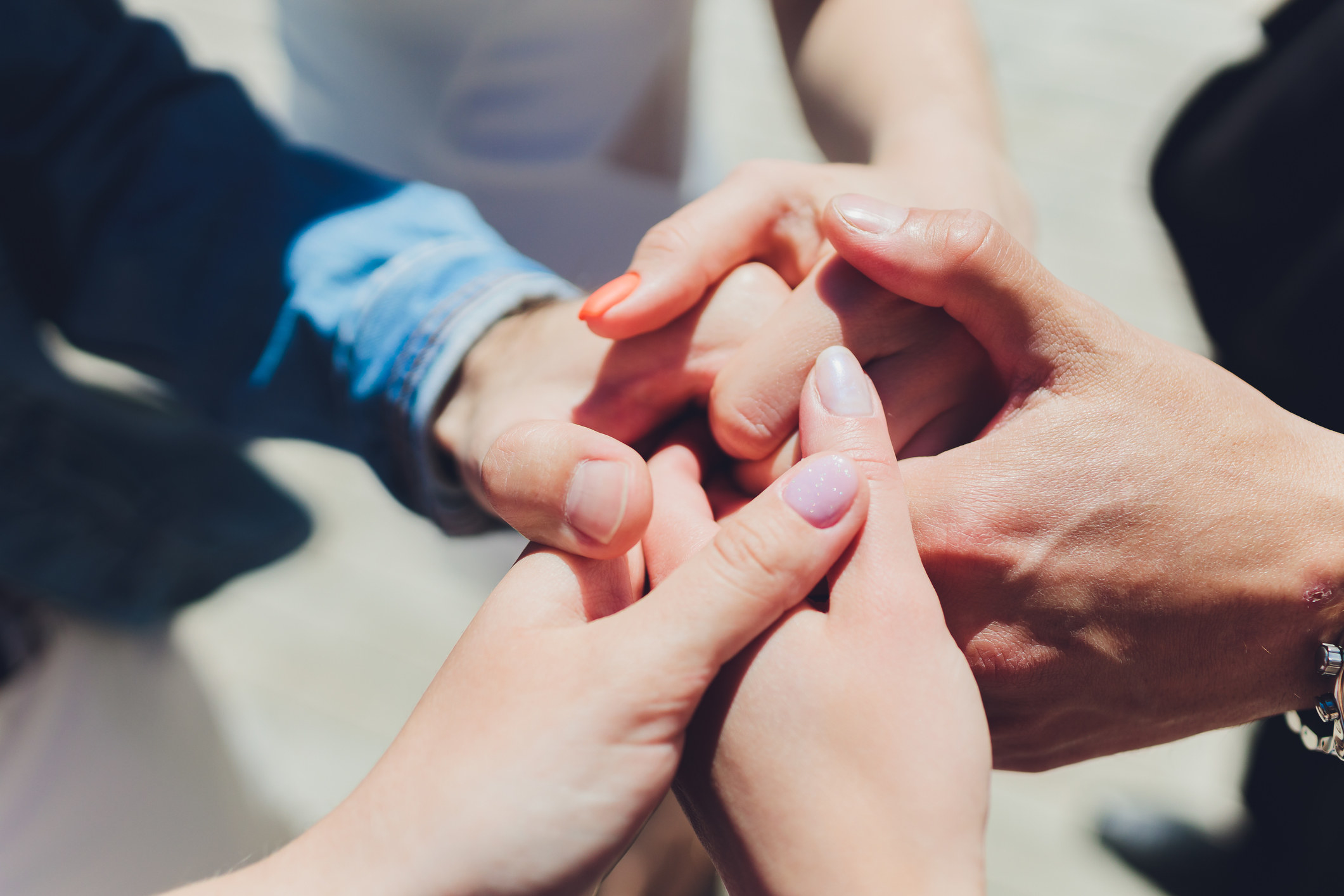 many hands holding each other