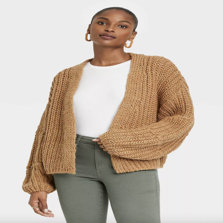 A model posing in the tan cardigan