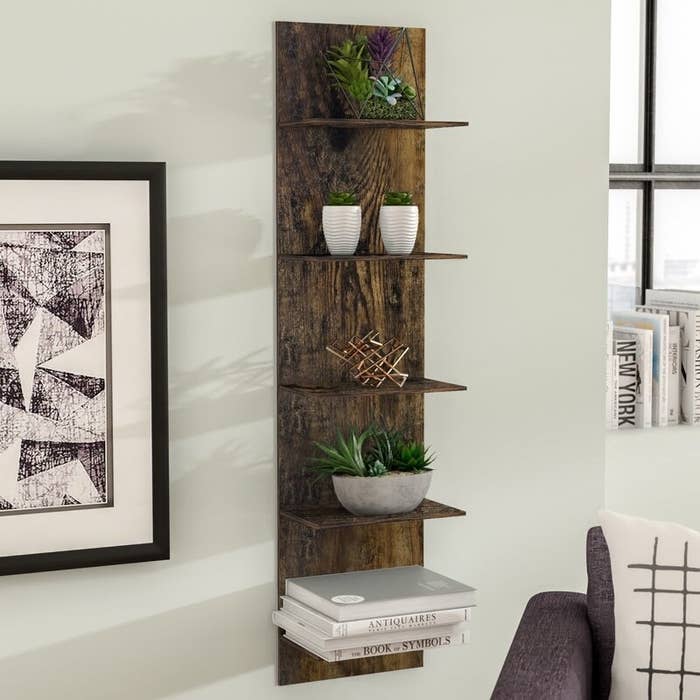 A five-tier floating shelf in pine mounted on the wall