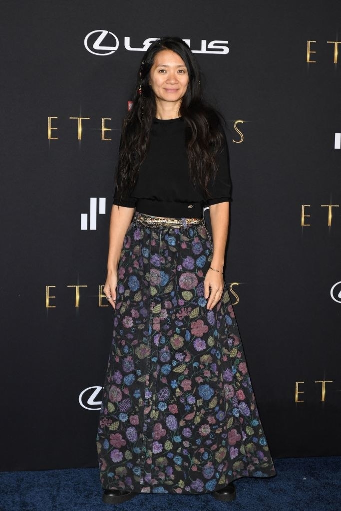Chloe Zhao poses on the red carpet of The Eternals premiere