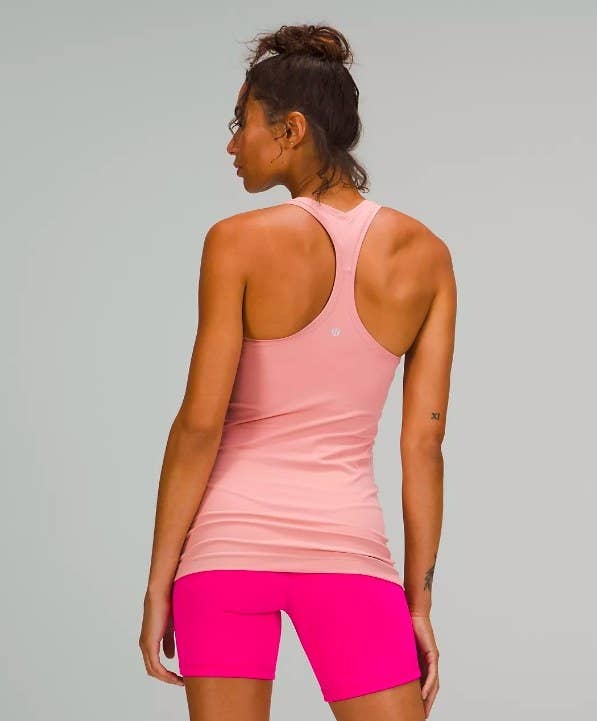 Model shown from the back wearing the pink racerback shirt
