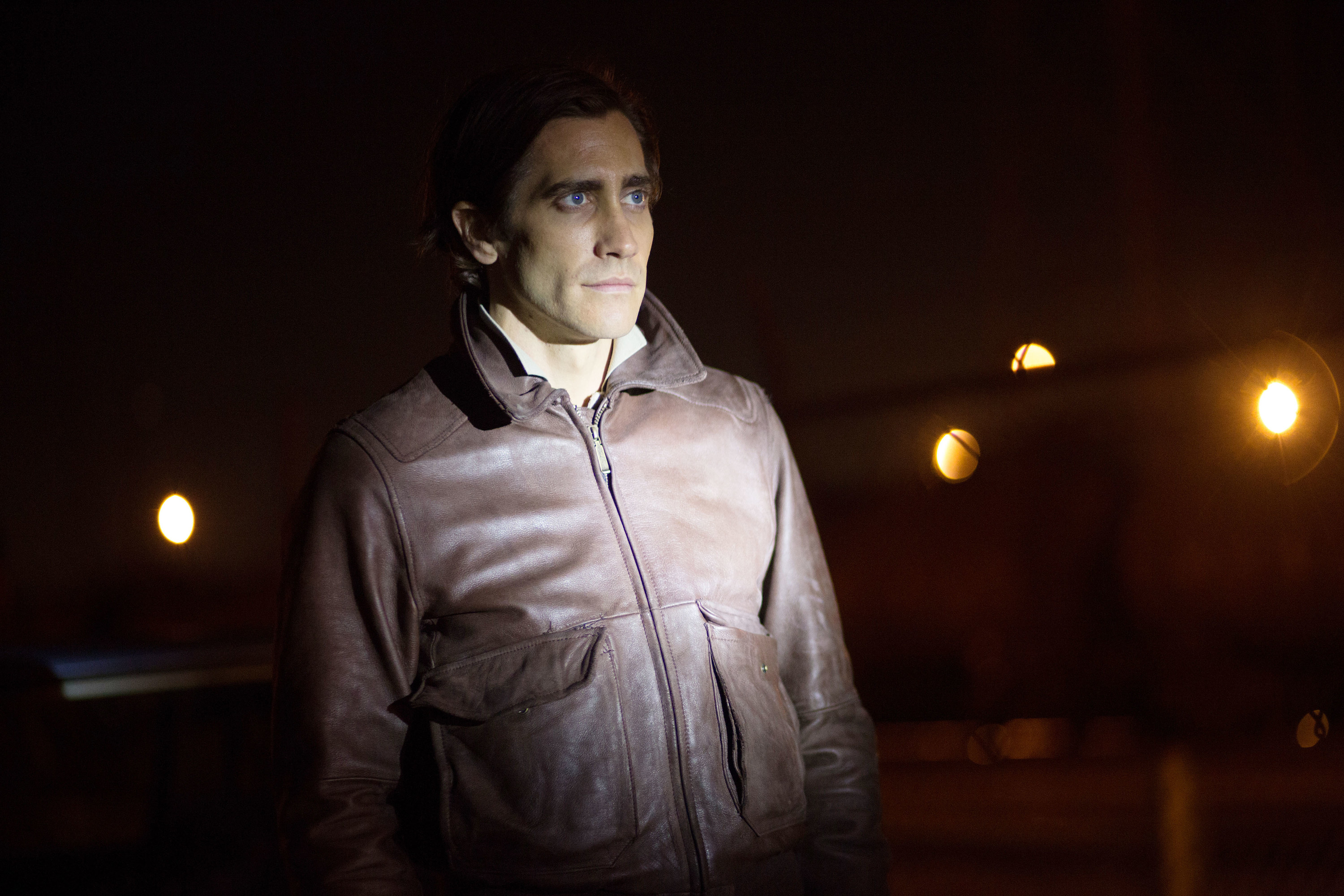 Gyllenhaal as Lou outside with a light shining on his body