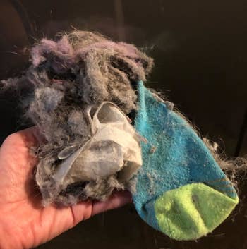 Reviewer photo of sock and lint sucked out of the dryer with the vent cleaner