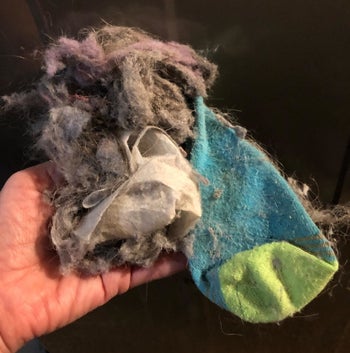 Reviewer photo of sock and lint sucked out of the dryer with the vent cleaner