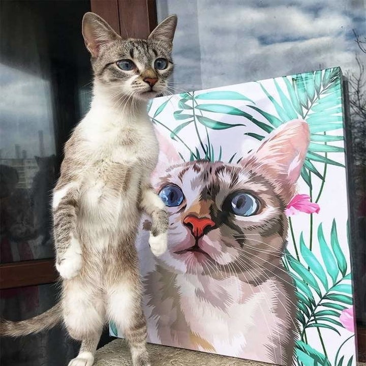 Cat standing next to its portrait