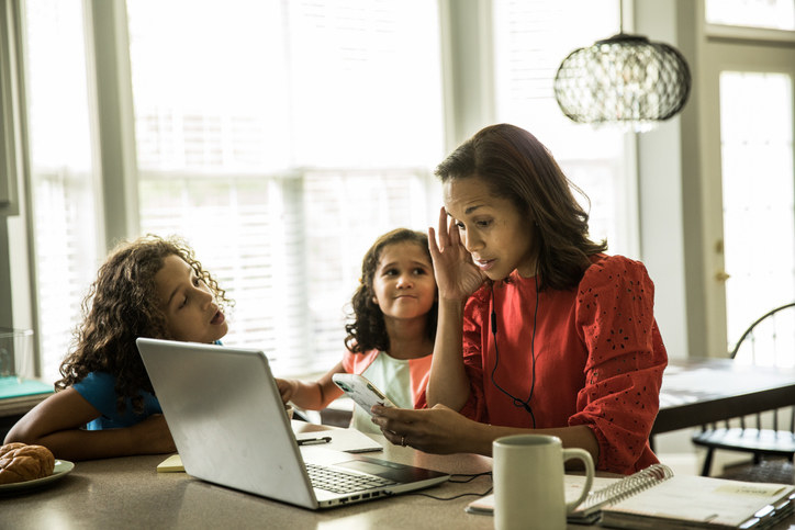 Parent looking stressed with two children