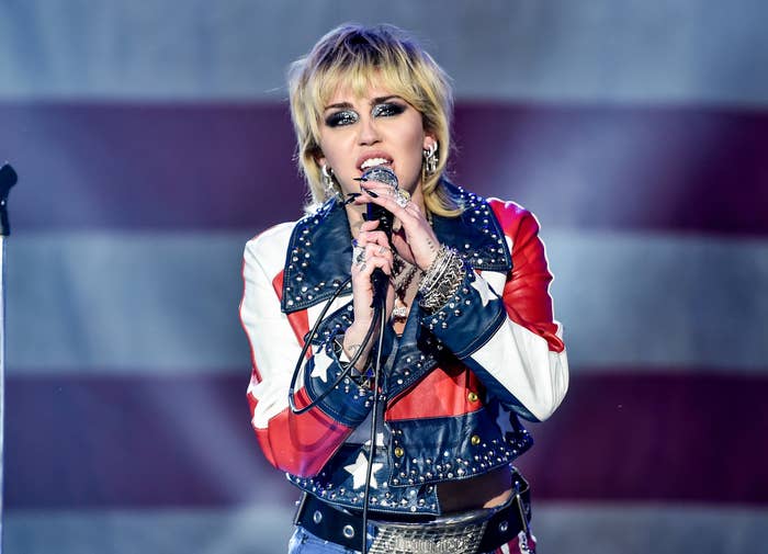 Miley performs on stage an American flag leather jacket