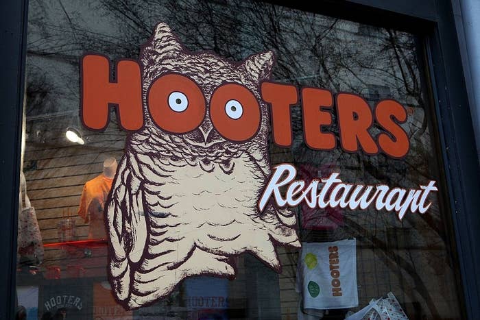 Hooters restaurant sign with an owl whose eyes look through the Os
