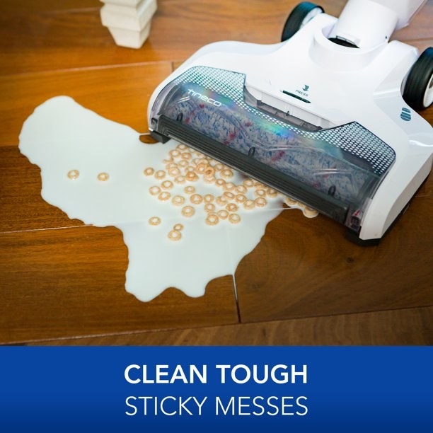 vacuum picking up spilled cereal and milk