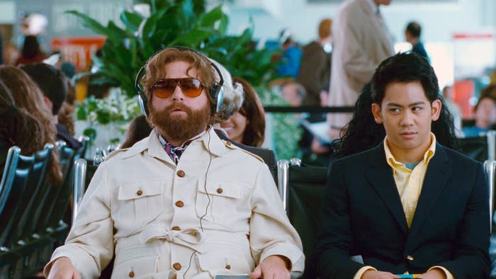 Galifianakis sits in an airport with headphones on