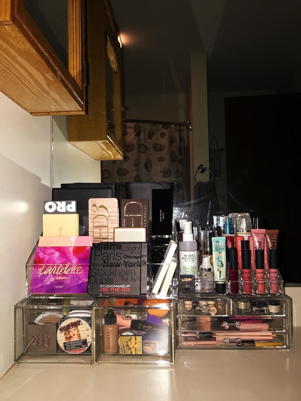 reviewer image of the drawers filled with cosmetic items stacked on each other on a counter space