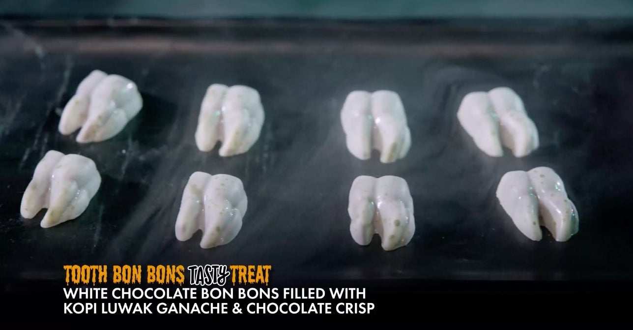 tooth shaped treats with text &#x27;white chocolate bon bons filled with kopi luwak ganache &amp;amp; chocolate crisp&#x27;