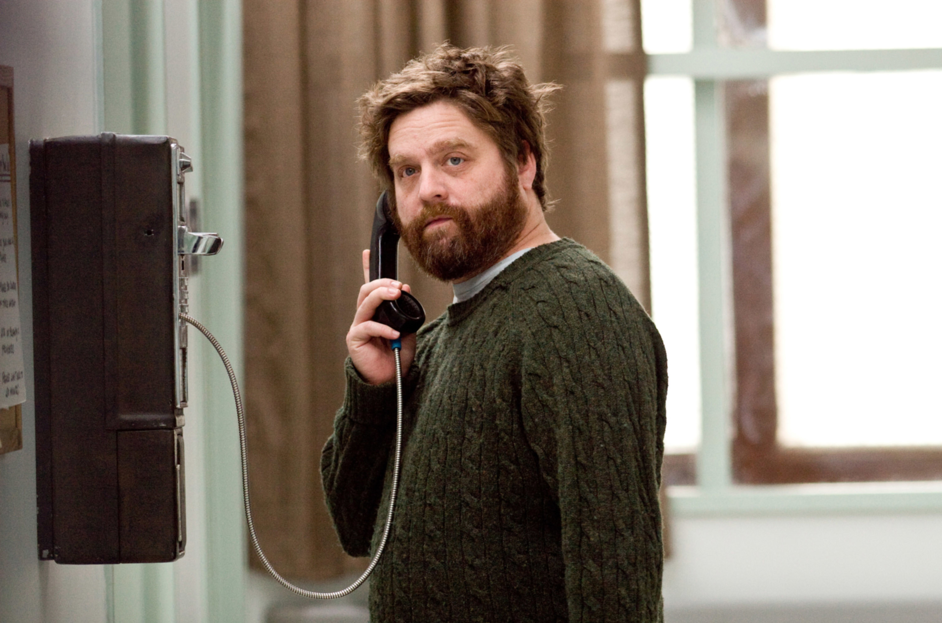 Galifianakis uses a pay phone inside