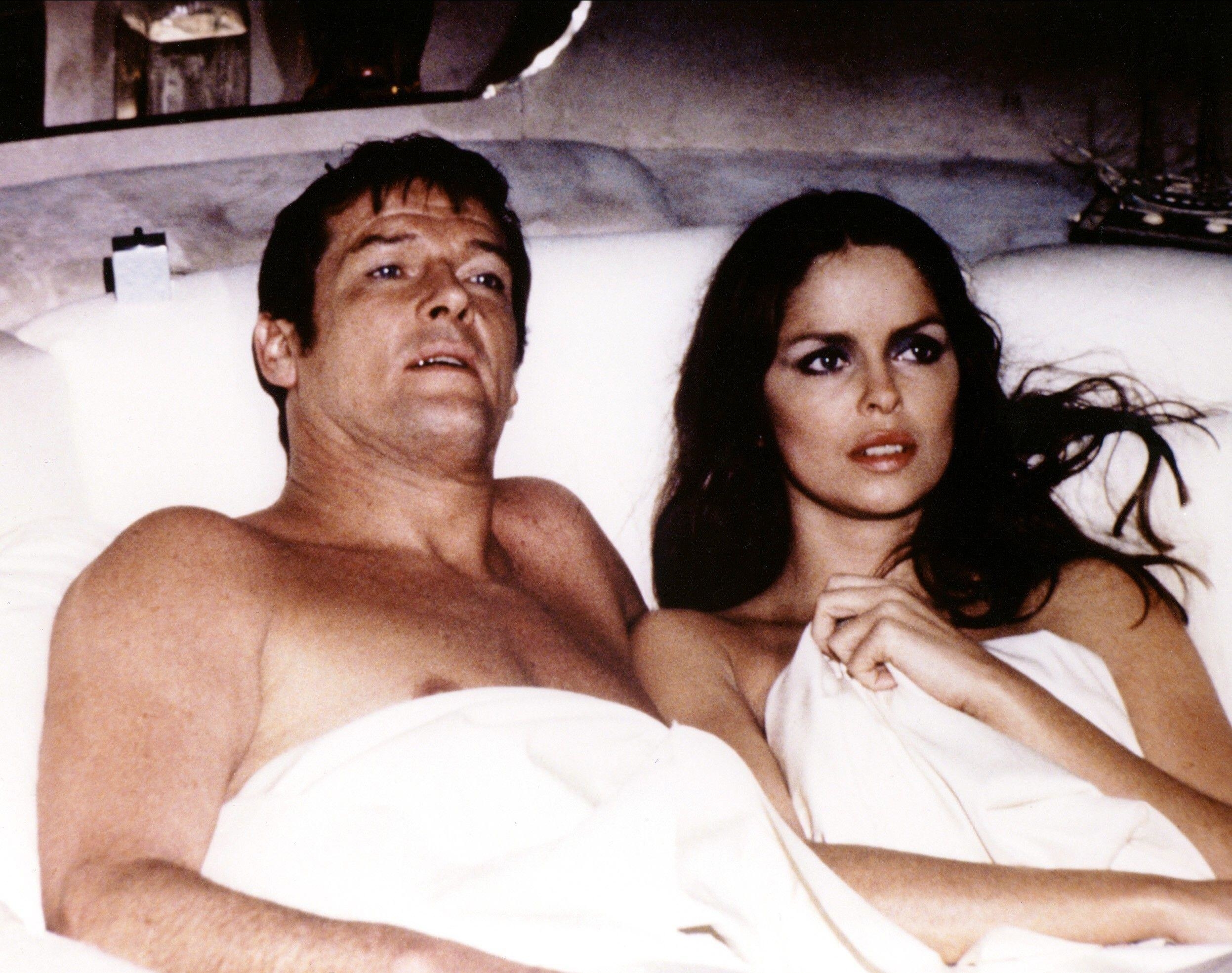 James Bond and a woman lying unclothed under the sheets