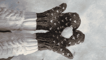 a gif of brown mittens with little hearts sewn into them