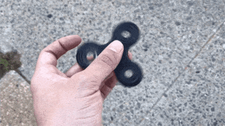 Person holding a fidget spinner