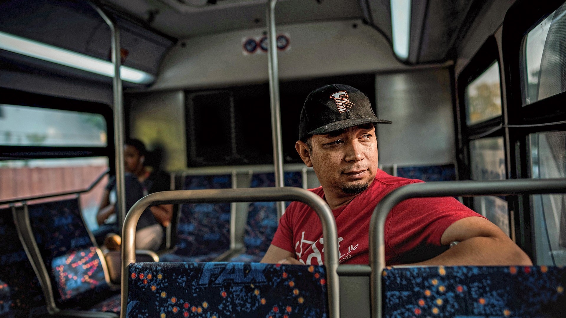 A person looking out the window as they ride on a bus