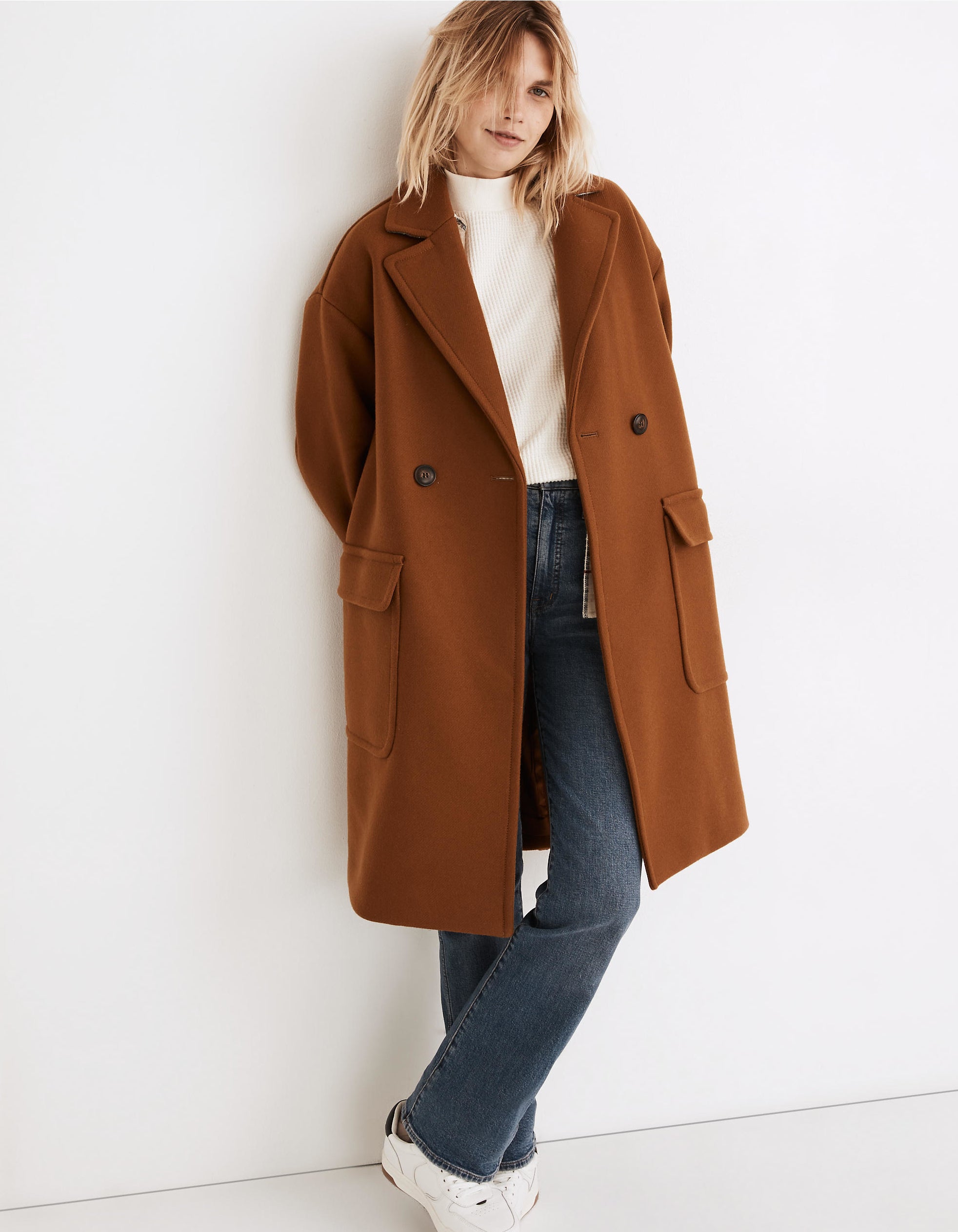 a model in a warm brown peacoat