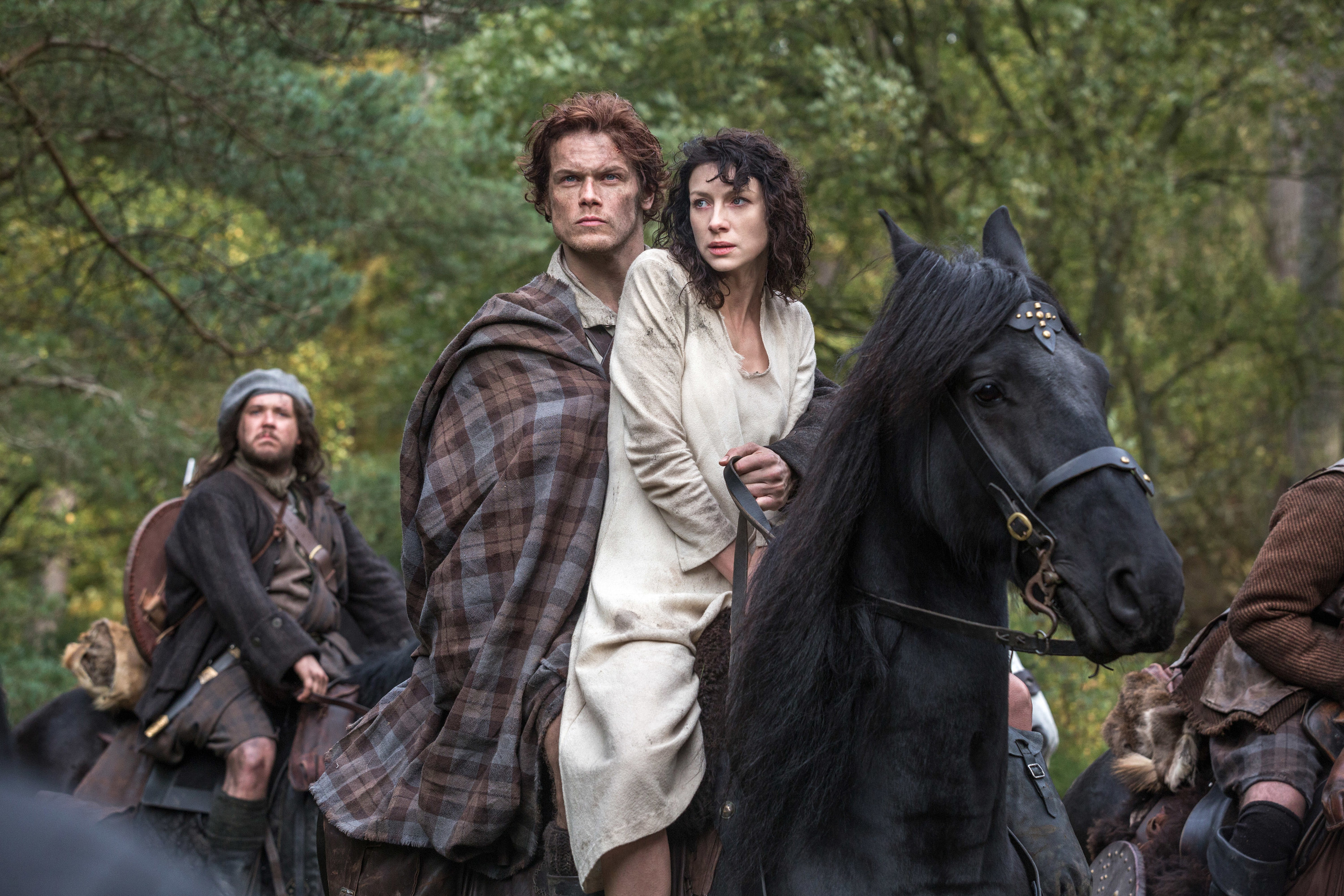 Jamie rides on a horse with Claire