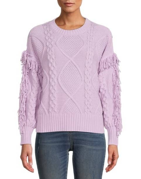 a model wearing the fringe sweater in purple