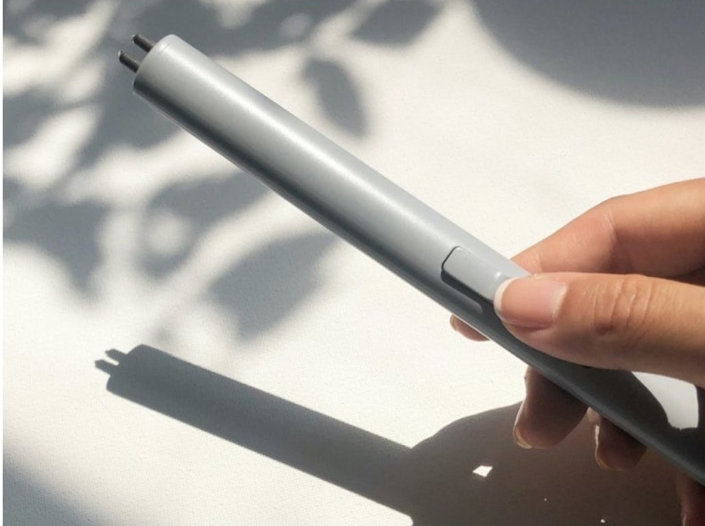 Model holding a white lighter.