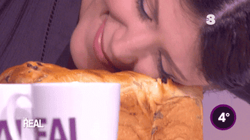 GIF of a woman rolling her face on a loaf of bread