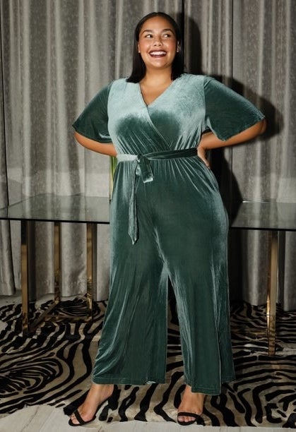 a model wearing the v-neck tie-front velvet jumpsuit in teal