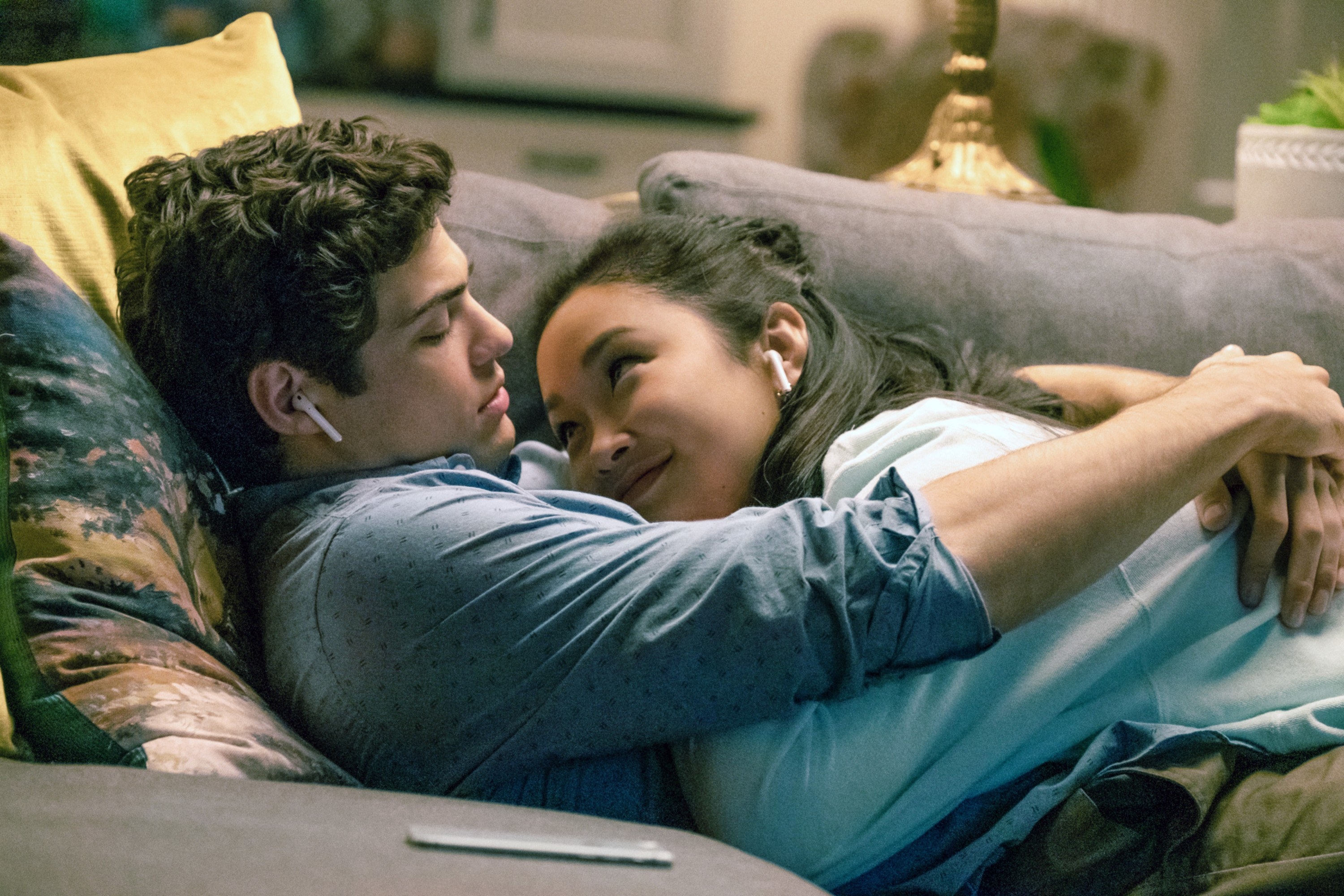 Lara Jean and Peter cuddling on couch