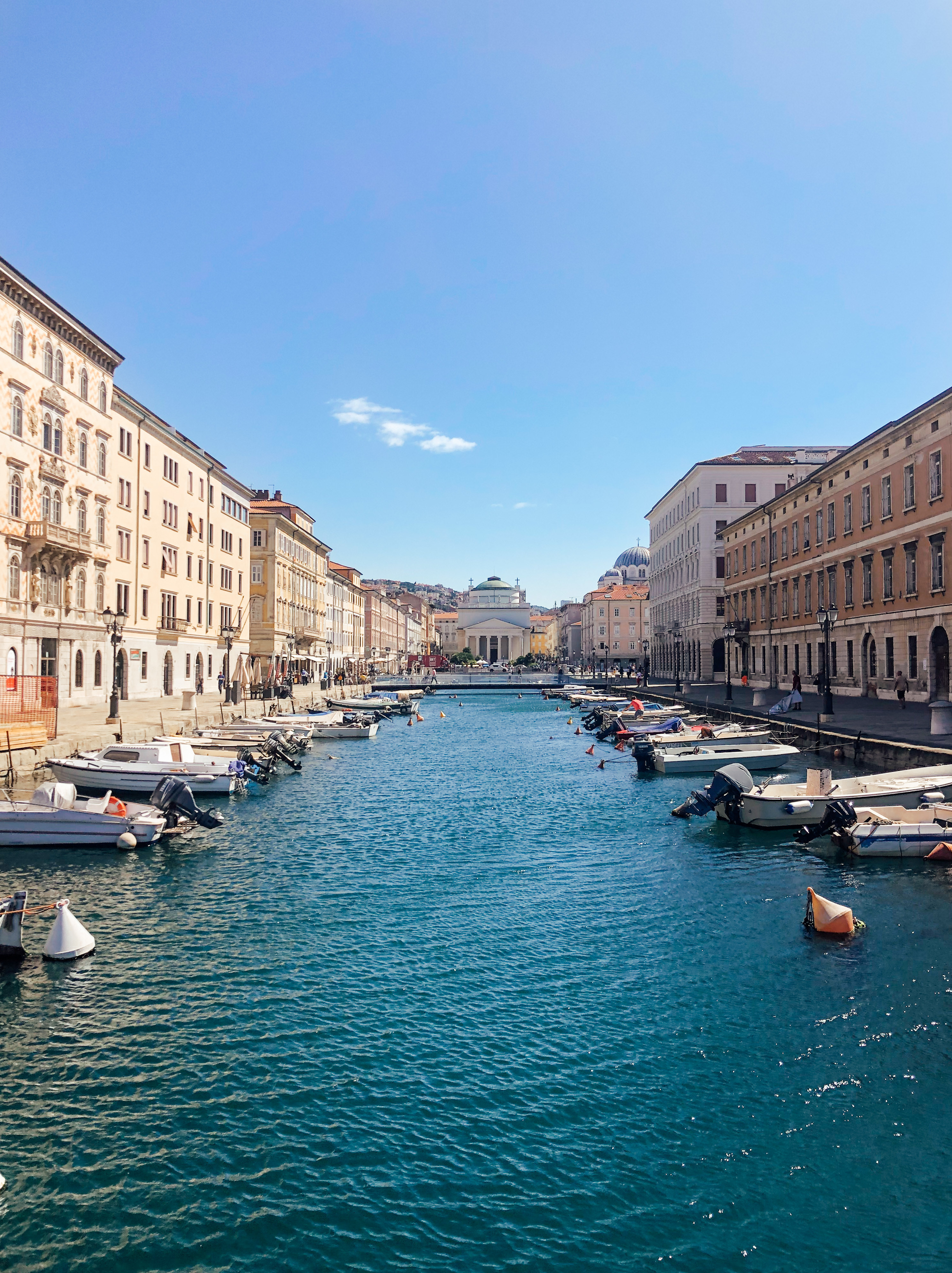 Port city of Trieste&#x27;s downtown area with boats lining the marina.