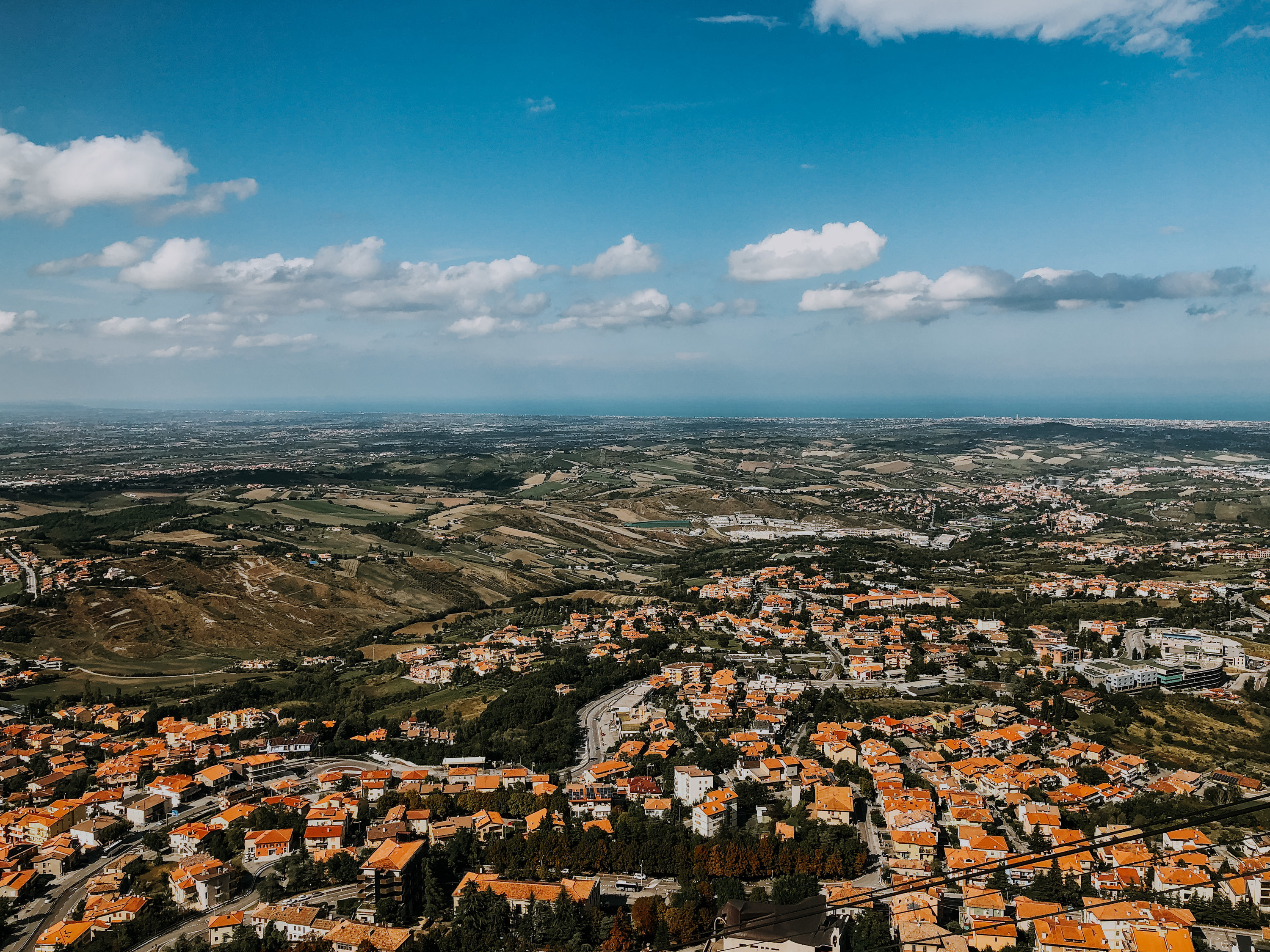 View from San Marino with houses, mountains, and the ocean in the distance