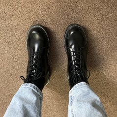 A reviewer showing the black combat boots