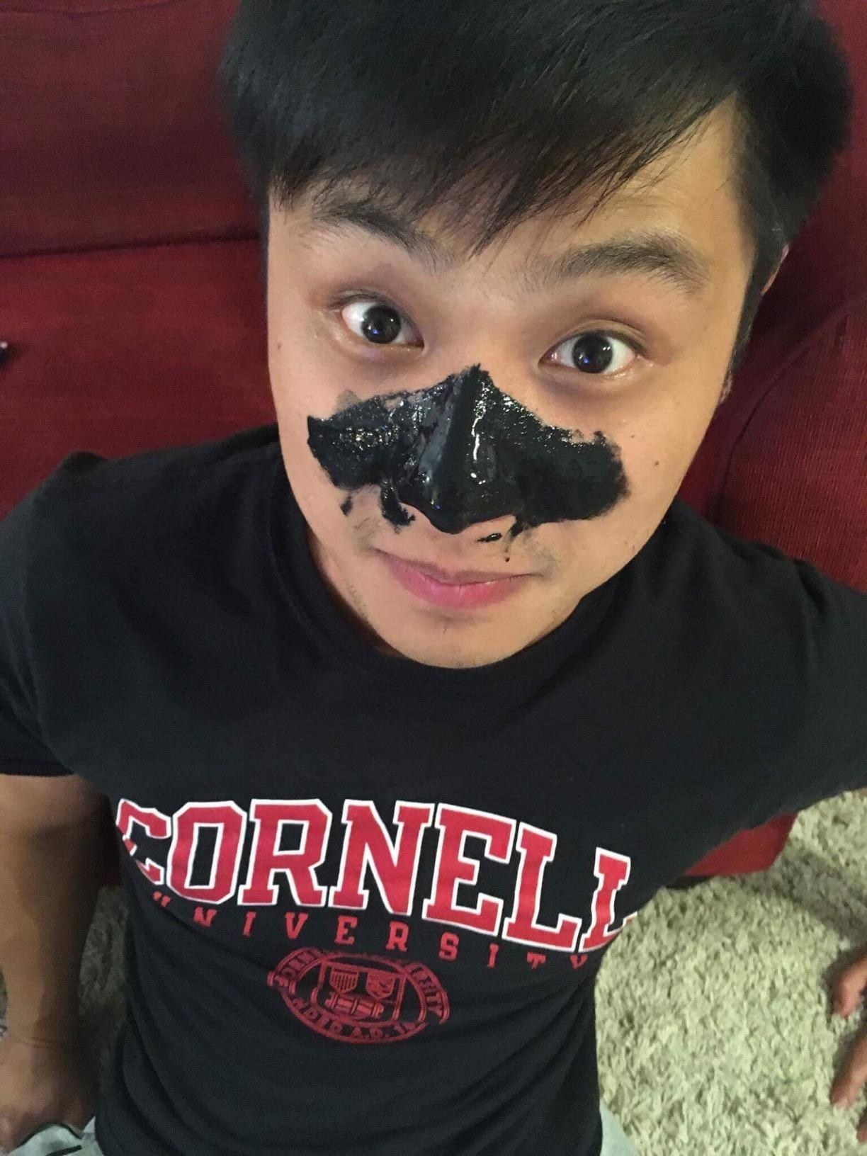 Reviewer with black peel-off mask on nose