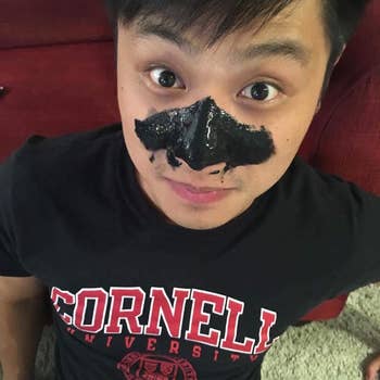 Reviewer with black peel-off mask on nose