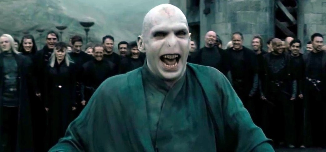 voldemort laughing while his supporters cheer behind him