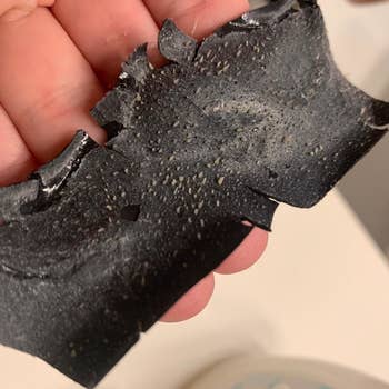 Reviewer holding used nose pore strip