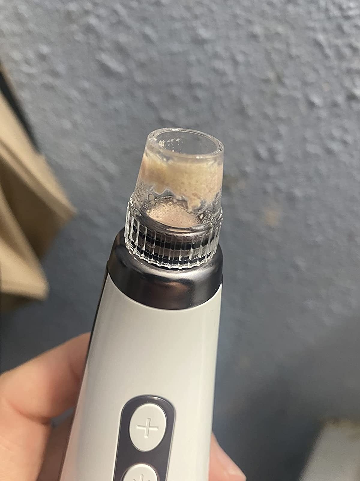 Reviewer holding pore vacuum after using it