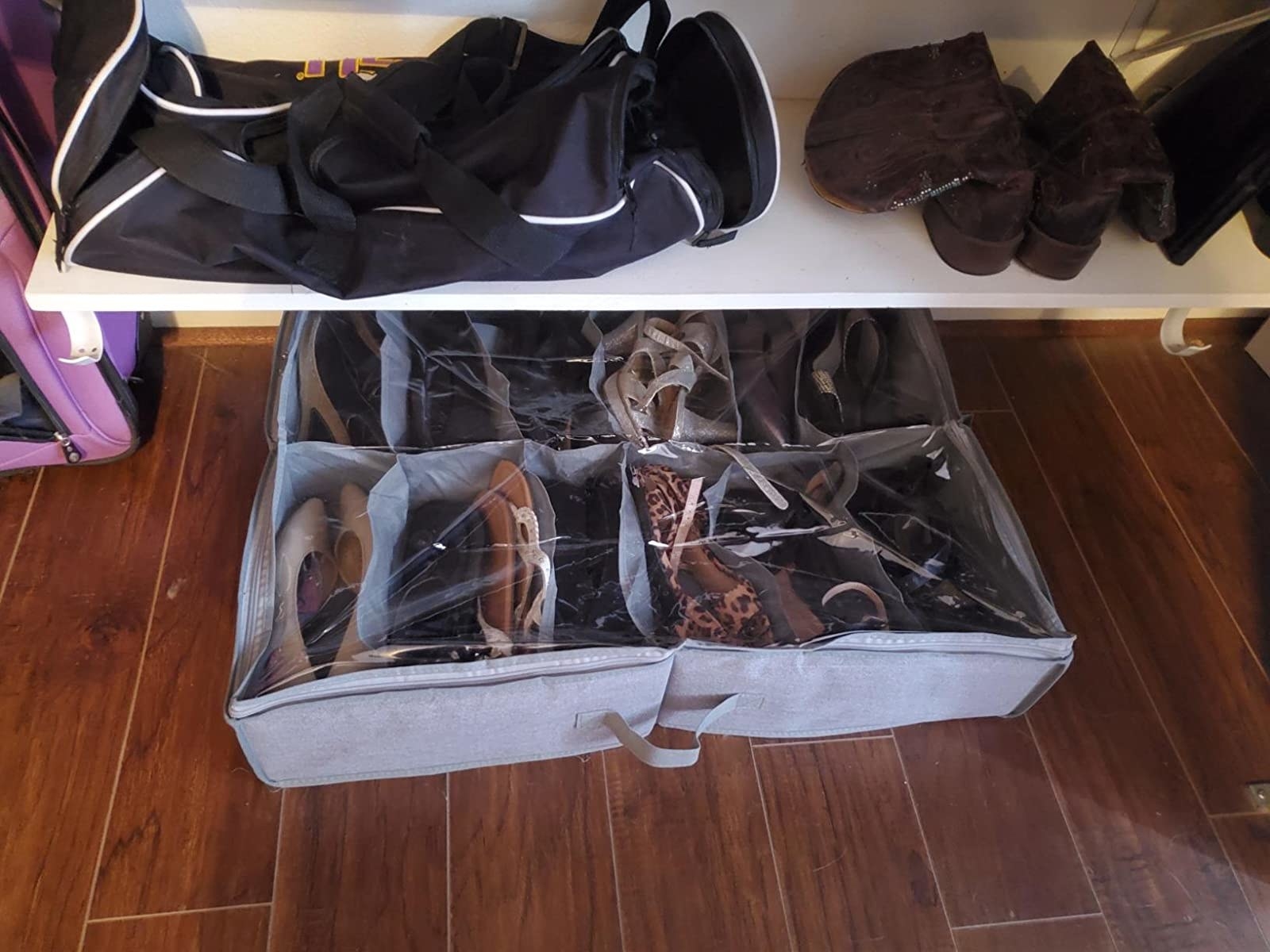 reviewer image of the shoe organizer full of shoes slid under a bench with a bag and boots on top